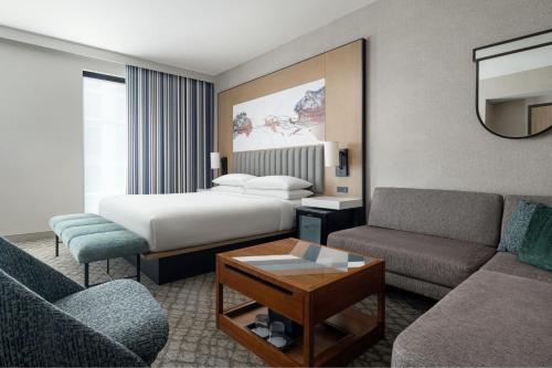 a hotel room with a bed and a couch at Austin Marriott Downtown in Austin
