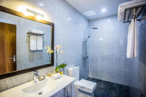 a bathroom with a sink and a shower and a toilet at LakRaj Heritage in Matara