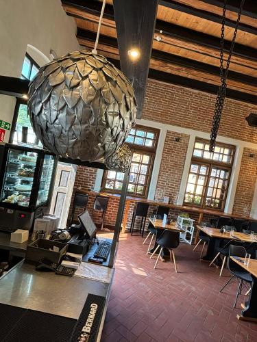 a restaurant with tables and a large ball hanging from the ceiling at Boutique hotel Barvirna in Český Krumlov