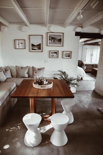 a living room with a table and a couch at Stanley Island in Plettenberg Bay