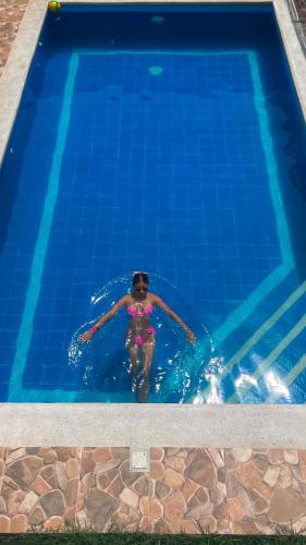 a person swimming in a swimming pool at Rincon del Mar Palomino in Palomino