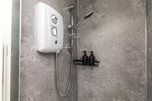 a shower in a bathroom with a soap dispenser at Dove Court Travel Lodge 2 - First Floor Ensuite in Bristol