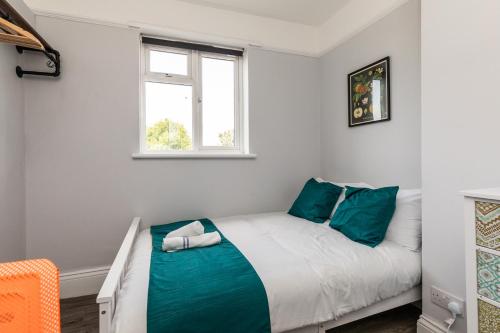a small bedroom with a bed with blue pillows at Dove Court Travel Lodge 2 - First Floor Ensuite in Bristol