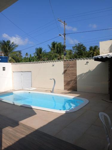 a swimming pool in the backyard of a house at Casa Jacuipe temporada in Camaçari