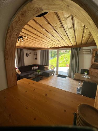 a living room with a large wooden ceiling at Ferienwohnung Nockberge in Staudach