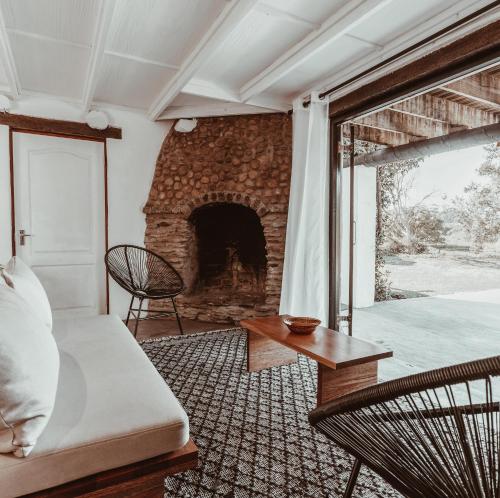 a living room with a couch and a fireplace at Stanley Island in Plettenberg Bay