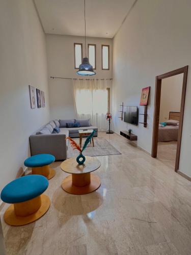 a living room with two stools and a couch at Take the Best Rest Near the airport in Nouaceur