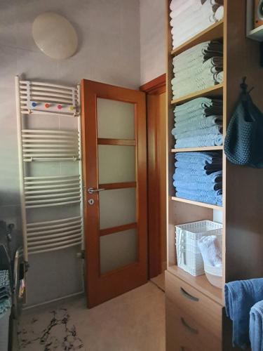 a closet with a door and a bunch of towels at La Grande Apartments in Kotor