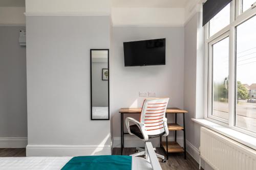a bedroom with a desk and a chair next to a window at Dove Court Travel Lodge 3 - First Floor Ensuite in Bristol