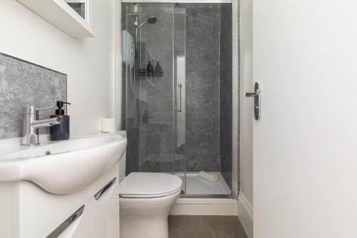 a bathroom with a shower and a toilet and a sink at Dove Court Travel Lodge 3 - First Floor Ensuite in Bristol