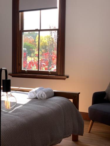 a bedroom with a bed and a window at On Chapel St, The Royal Hotel Dalton in Dalton