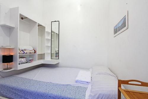 a small bedroom with a bed and a mirror at Jmt Star's Inn in General Luna