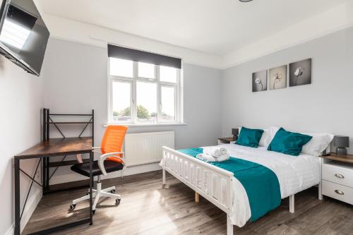 a bedroom with a bed and a desk and a chair at Dove Court Travel Lodge 4 - First Floor Ensuite in Bristol