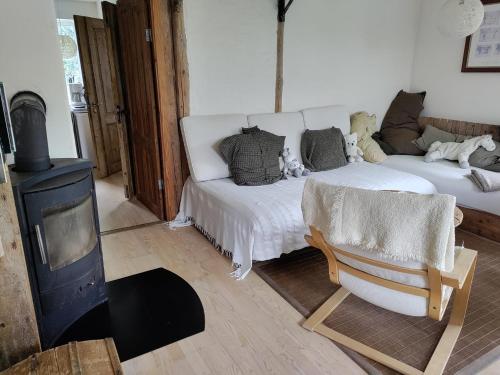 a living room with a white bed and a couch at Petersholm in Odder