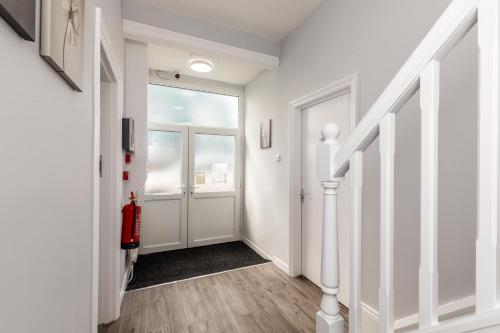 a hallway with white walls and a door at Dove Court Travel Lodge 5 - First Floor Ensuite in Bristol