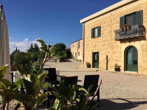 a building with chairs and a balcony on it at La Casa del Poeta Enna - Pergusa in Enna