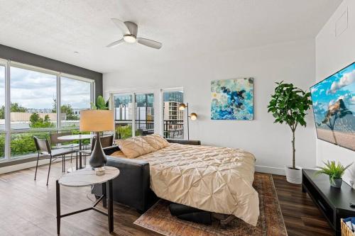 a bedroom with a bed and a living room with a table at Gorgeous Central City 2BD 2BA in Salt Lake City