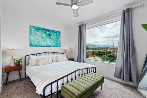 a bedroom with a bed and a large window at Gorgeous Central City 2BD 2BA in Salt Lake City