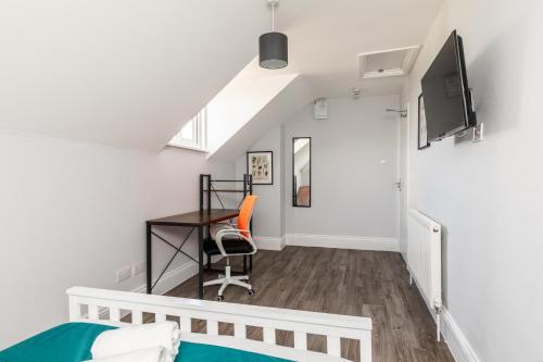 a bedroom with a bed and a desk at Dove Court Travel Lodge 6 - Top Floor Double Bedroom in Bristol