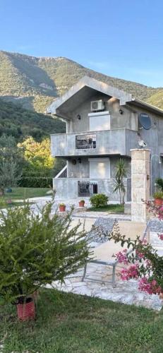 a building with a balcony and flowers in front of it at Studio Elena in Tivat