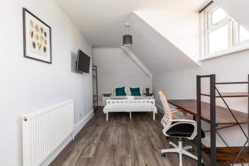 a white room with a desk and a bed at Dove Court Travel Lodge 6 - Top Floor Double Bedroom in Bristol