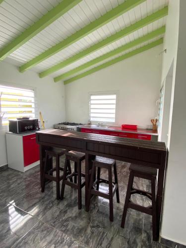 a kitchen with a wooden table and some stools at Tropic Arth Paradise in Port-Louis