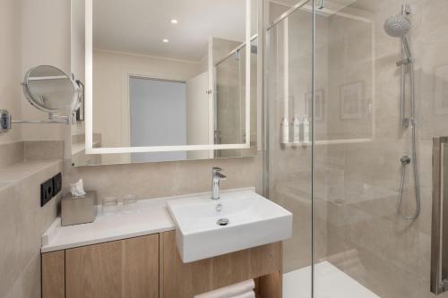 a bathroom with a sink and a shower at Courtyard by Marriott Milano Linate in Milan