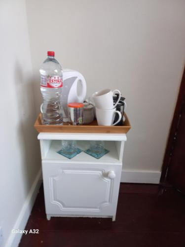 a small white cabinet with a bottle of water on top at Budget room in Foxford