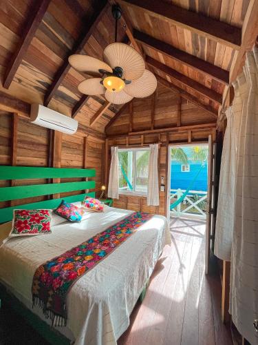 a bedroom with a bed and a ceiling fan at Whyknot Holbox in Holbox Island