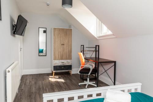 a living room with a desk and a chair at Dove Court Travel Lodge 7 - Top Floor Double Bedroom in Bristol