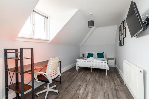 a attic room with a desk and a bed at Dove Court Travel Lodge 7 - Top Floor Double Bedroom in Bristol