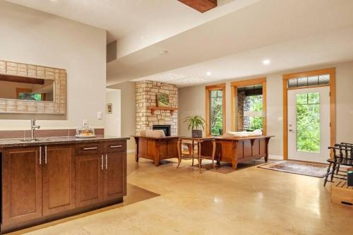 a kitchen with a table and a dining room at Escape to the Rockies but near Calgary Includes Free Parking and Banff Entry in Calgary