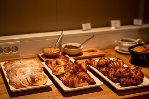 a table with several different types of pastries and bread at Hotel Jökull in Höfn