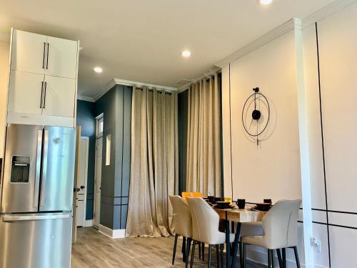 a kitchen and dining room with a table and a refrigerator at Beautiful Modern Muse with all you need within and around in Soulard