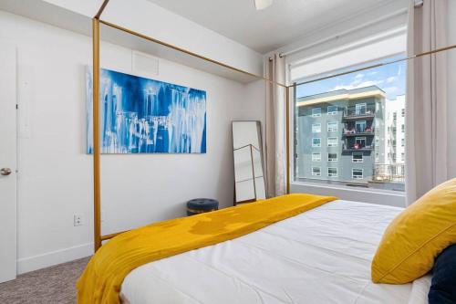 a bedroom with a bed and a large window at Luxury Apt 6th floor - King Bed Gym Prkg Pool NEW in Salt Lake City