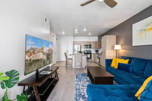 a living room with a blue couch and a table at Luxury Apt 6th floor - King Bed Gym Prkg Pool NEW in Salt Lake City
