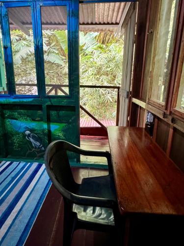 a dining room with a table and a fish tank at Hidden Jungle Beach House in Puerto Viejo