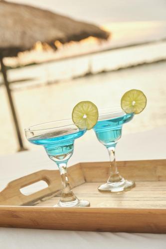 two blue cocktails sitting on a wooden tray at El Embrujo Tintipan in Tintipan Island