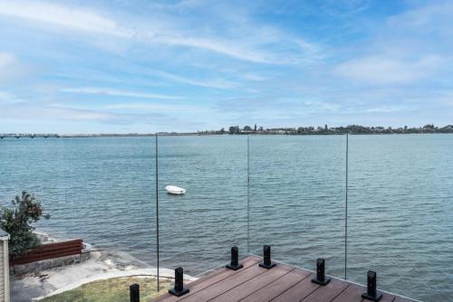 a view of a large body of water with a boat at Harbour View Motel and Waterfront Apartments in Tauranga