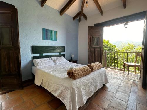 a bedroom with a bed and a balcony at La Villa The View in Pance
