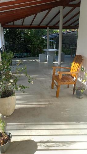 a wooden bench sitting under a pavilion at Subahas Backpacker in Galle