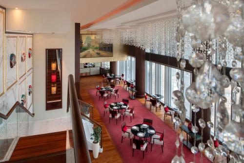 an overhead view of a dining room with tables and chairs at JW Marriott Marquis City Center Doha in Doha