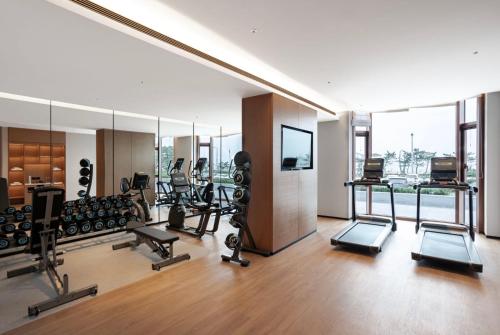 a gym with several treadmills and a mirror at Fairfield by Marriott Yantai in Yantai