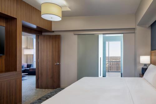 a bedroom with a bed and a sliding glass door at The Westin Galleria Dallas in Dallas