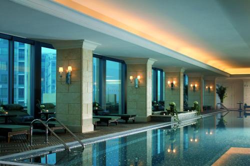 a hotel with a swimming pool in a building at The Ritz-Carlton Beijing in Beijing