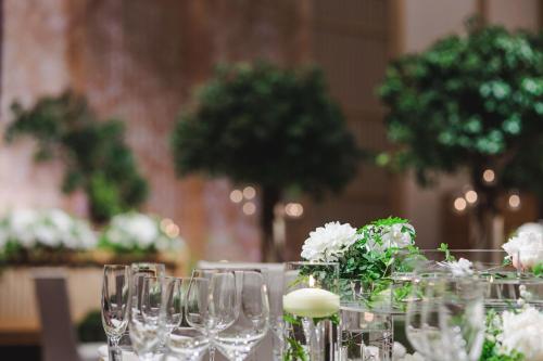 a table with wine glasses and flowers on it at The Ritz-Carlton Kyoto in Kyoto