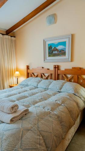 a bedroom with a bed with a towel on it at Cerro Pirámide Alojamiento in Caviahue