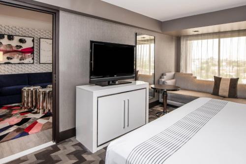 a hotel room with a bed and a flat screen tv at Beverly Hills Marriott in Los Angeles