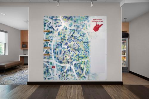 a large painting on a wall in a room at TownePlace Suites Bridgeport Clarksburg in Bridgeport