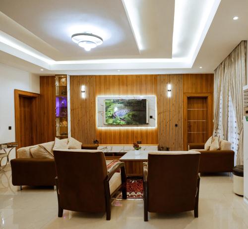a living room with a couch and a table at Elite Luxury 3-bedroom Apartment in Abuja in Abuja